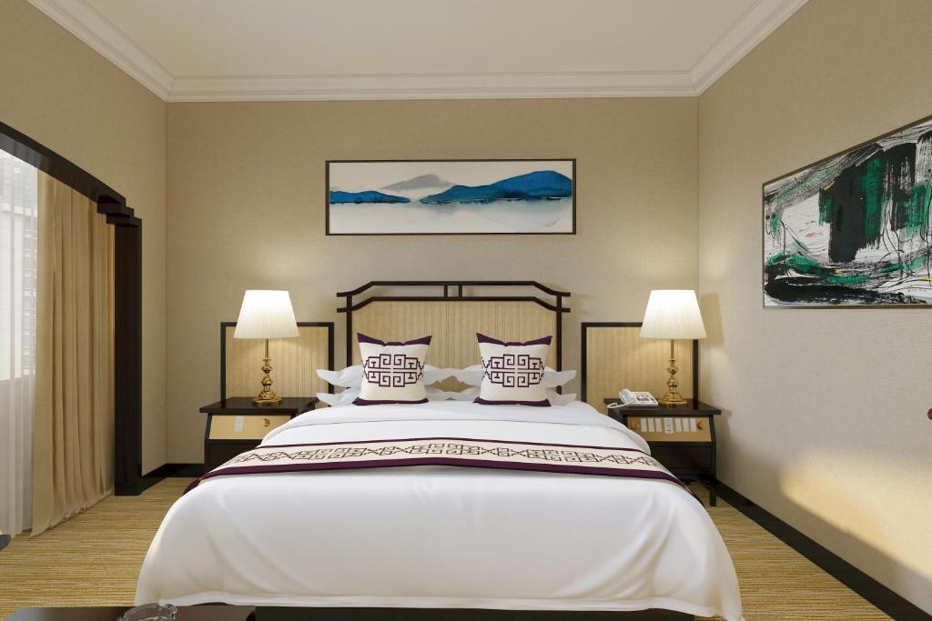 Postel nebo postele na pokoji v ubytování Yindo Jasper Hotel Zhuhai