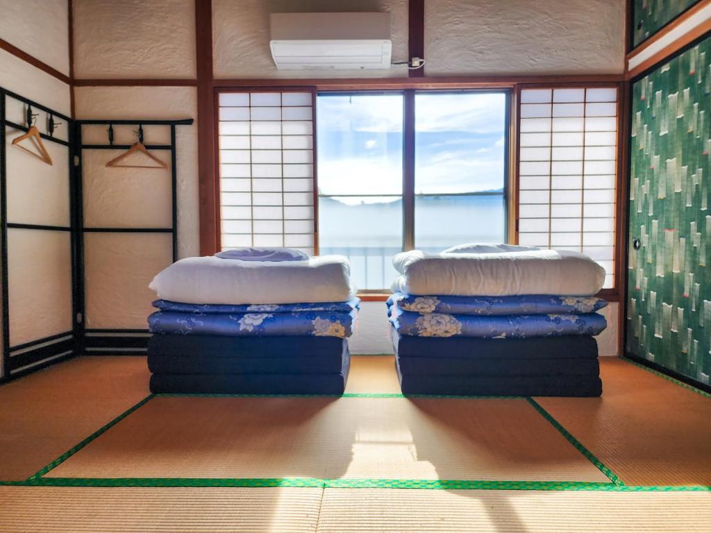 Postel nebo postele na pokoji v ubytování Guesthouse Mikansei