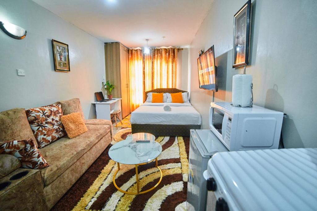ナイロビにあるONEAL URBAN SUITES - Furnished Studio apartments in Nairobiのソファとベッドのあるリビングルーム