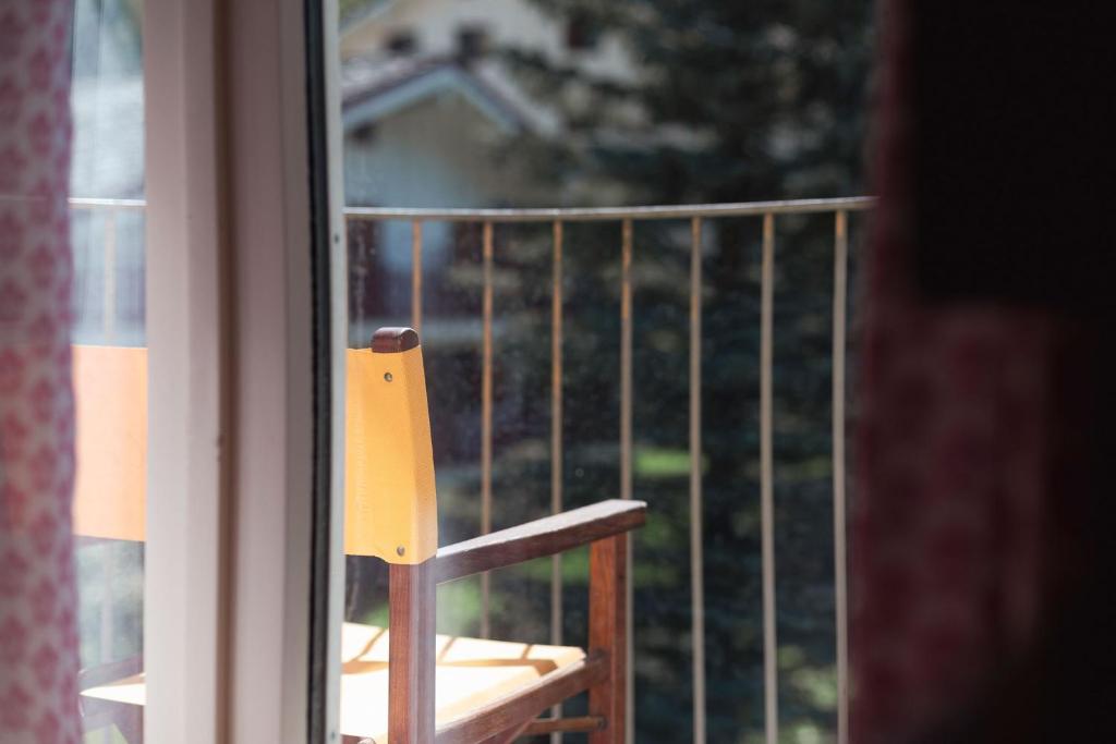 a wooden chair sitting on a window sill at Hotel Bouton d'Or - Courmayeur in Courmayeur