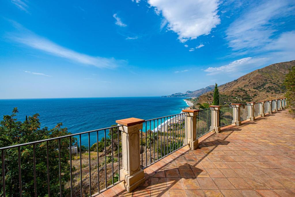 a balcony with a view of the ocean at Baia Taormina - CDSHotels in Forza dʼAgro