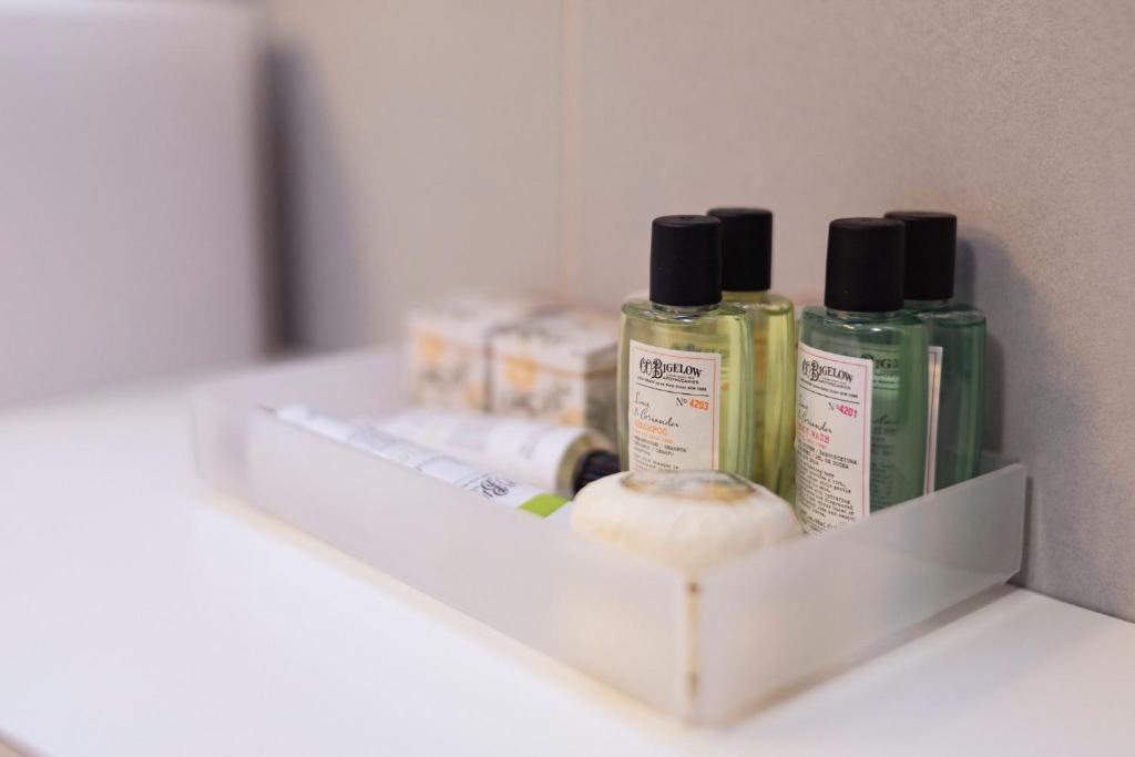 a shelf with three bottles of hair products on it at Hotel Bouton d'Or - Courmayeur in Courmayeur