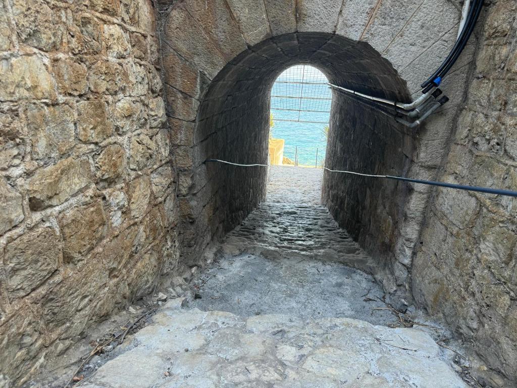 an alley way with an archway in a brick wall at Baia Taormina - CDSHotels in Forza dʼAgro