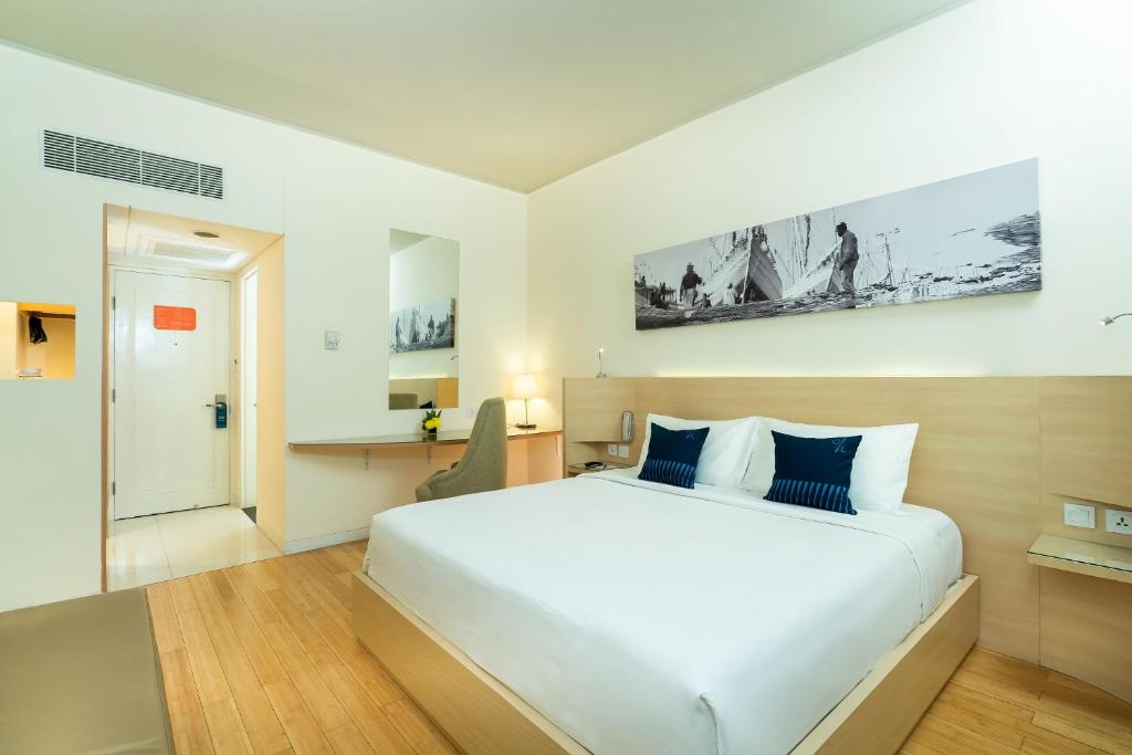 Postel nebo postele na pokoji v ubytování Cityloog Hotel Tebet Jakarta