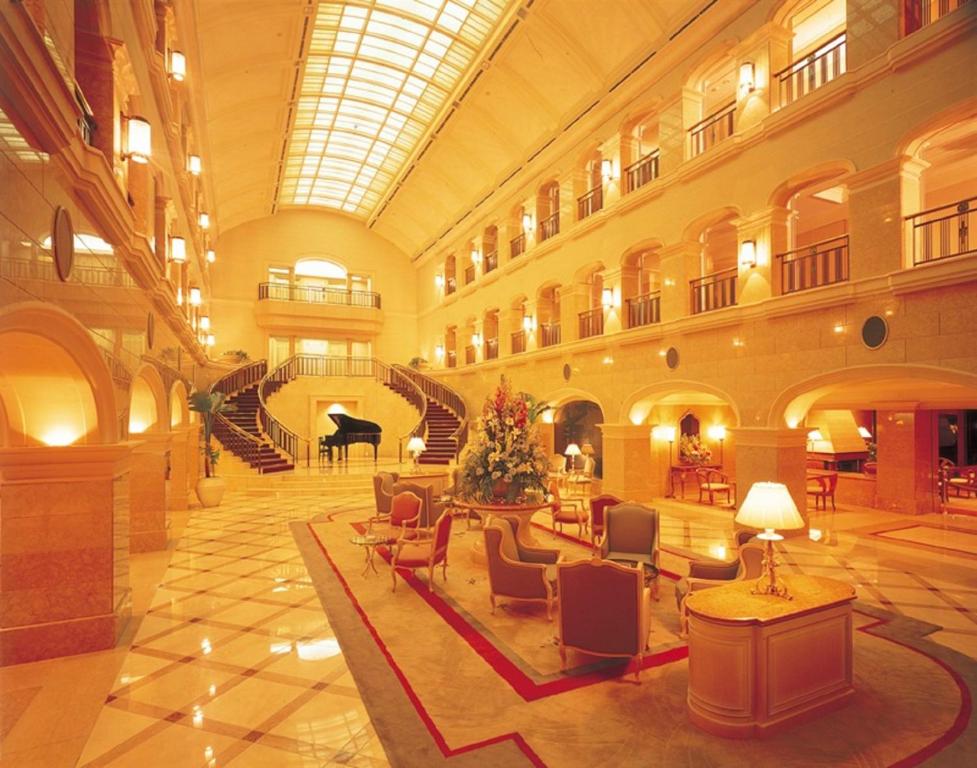 a large building with a grand lobby with a grand piano at Hotel de Premiere Minowa in Inawashiro