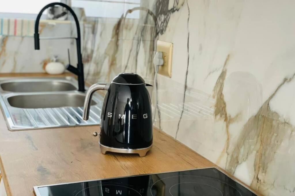 a tea kettle sitting on top of a kitchen counter at A zen and chic beachfront apartment in Swakopmund