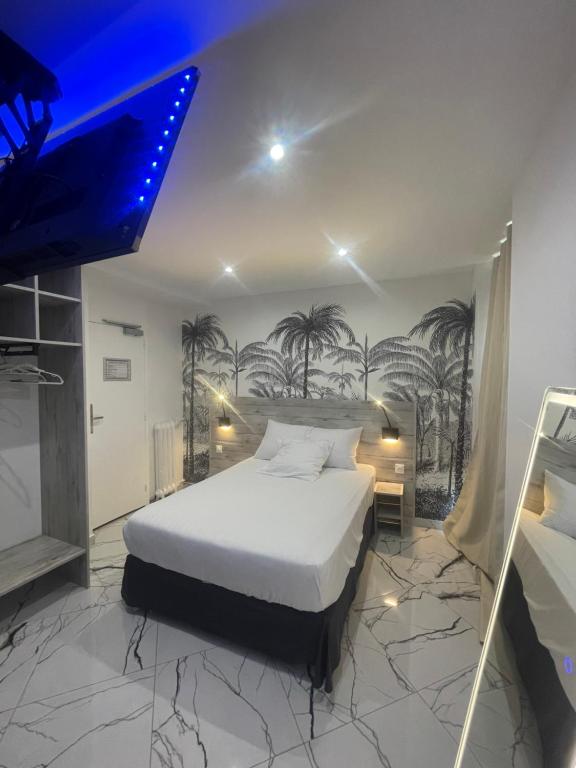 a bedroom with a bed with palm trees on the wall at Modern's Hotel in Paris