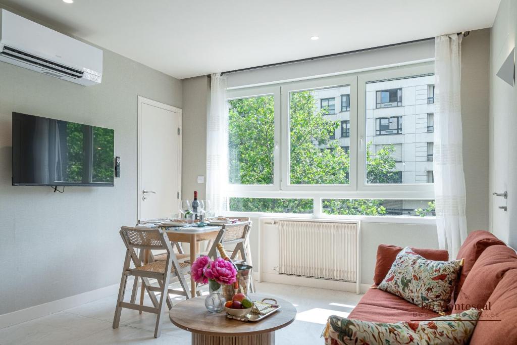 a living room with a couch and a table at De Montescal - SPA Tub and AC Cosy apartment a prime location 40m2 in Paris