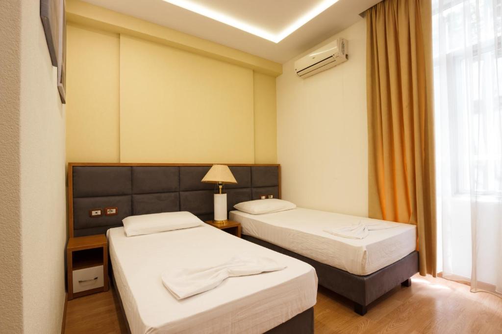 Postel nebo postele na pokoji v ubytování Hotel Cajupi