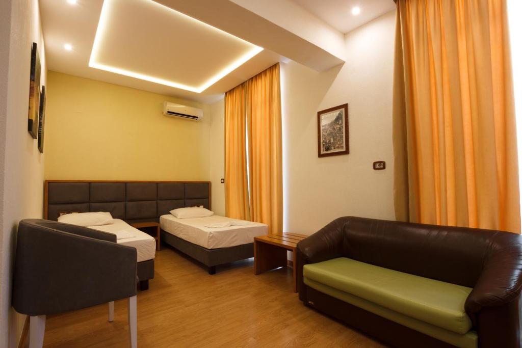 Postel nebo postele na pokoji v ubytování Hotel Cajupi