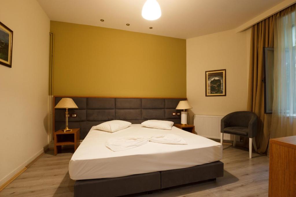 Postel nebo postele na pokoji v ubytování Hotel Cajupi