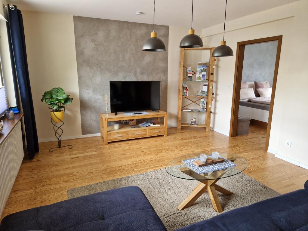 a living room with a couch and a tv at Haus Monika in Zeltingen-Rachtig