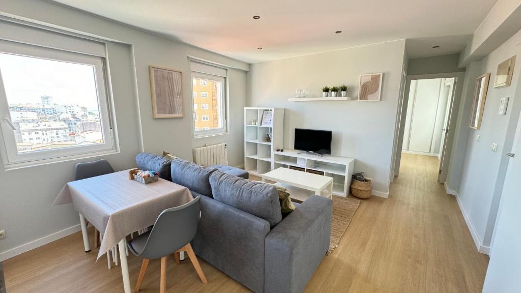 a living room with a couch and a table at Acogedor apartamento en Ronda Outeiro 210 in A Coruña