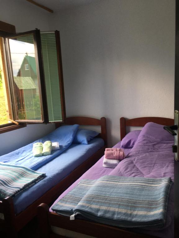 Postel nebo postele na pokoji v ubytování Apartmani Vila Šljukić