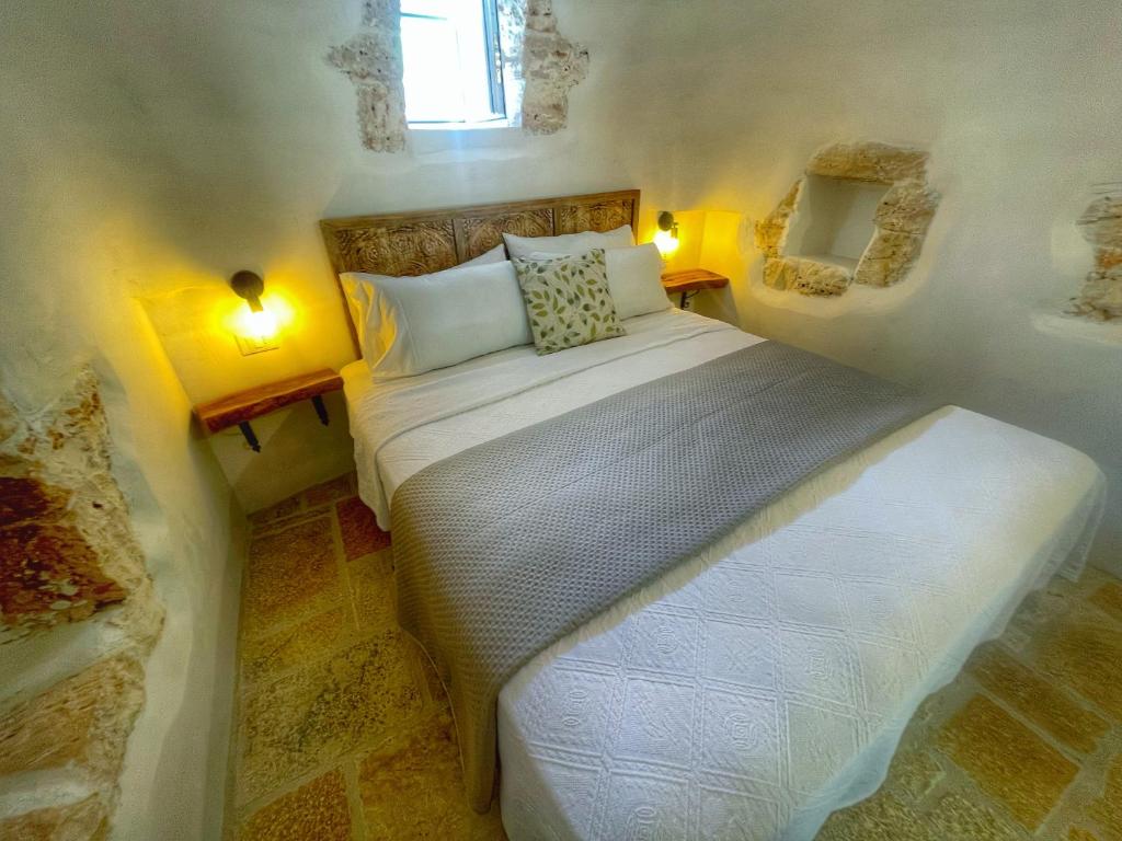 a bedroom with a bed in a small room at Trullideserio in San Michele Salentino
