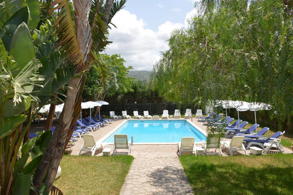 a swimming pool with lounge chairs and a swimming pool at Saphira by Penta Dream House in Campofelice di Roccella