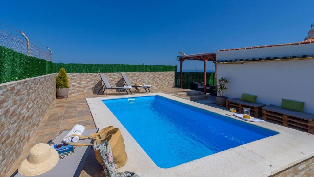 a swimming pool in a yard next to a house at Casa Maria de Velez Almayate Alto by Ruralidays in Almayate Alto