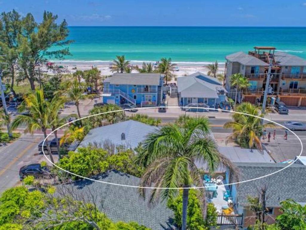 an aerial view of a beach with buildings and the ocean at Playa Esmeralda One Bedroom Cottages in Bradenton Beach