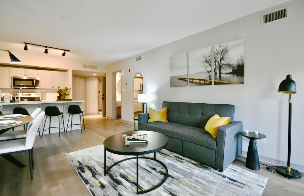 a living room with a couch and a table at Horseshoe Valley Bliss - Luxe Condo Retreat with Jacuzzi - Top Floor Romance - Self-Check-in - Indoor & Outdoor Heated Pool Haven in Shanty Bay