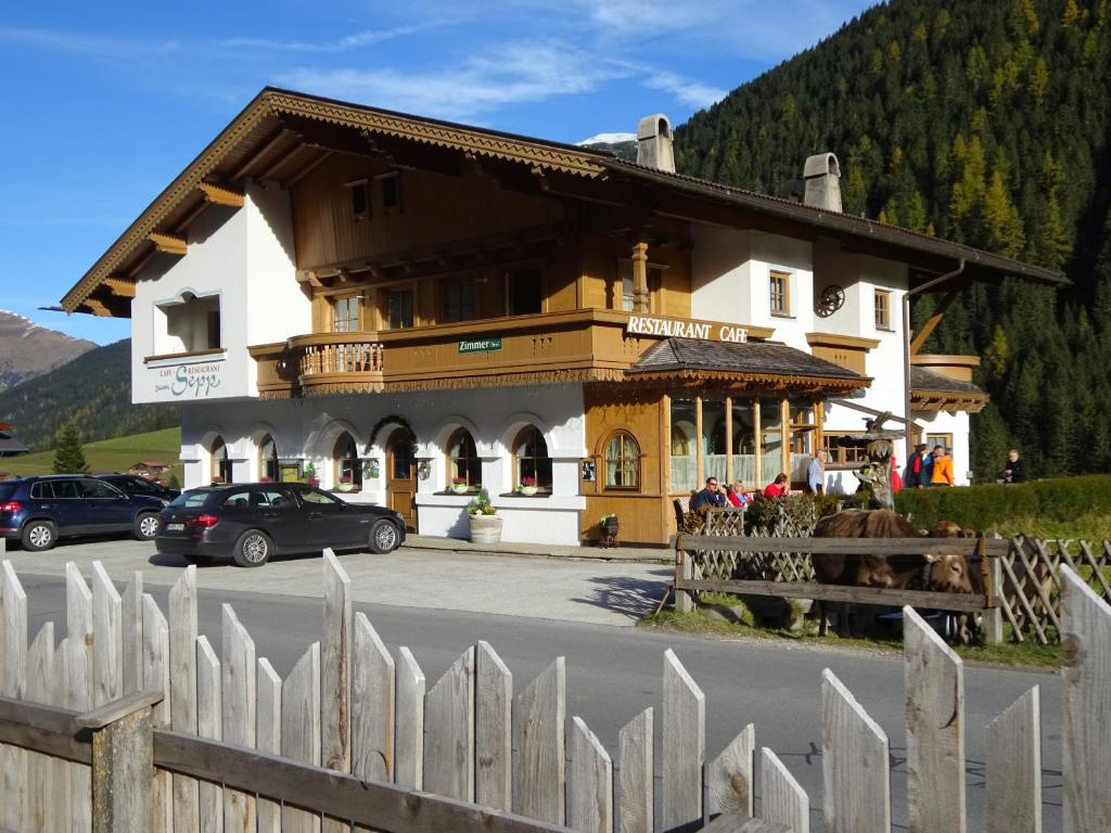 a large building with a fence in front of it at Zum Sepp in Tux