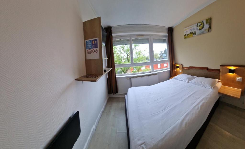 Postel nebo postele na pokoji v ubytování Hôtel OpalOriental