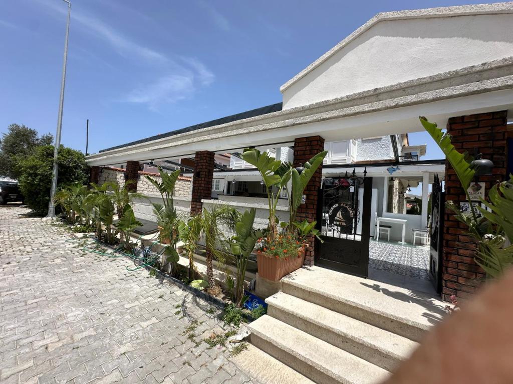 a house with plants in front of it at Grand Alaçatı Butik Hotel in Alaçatı