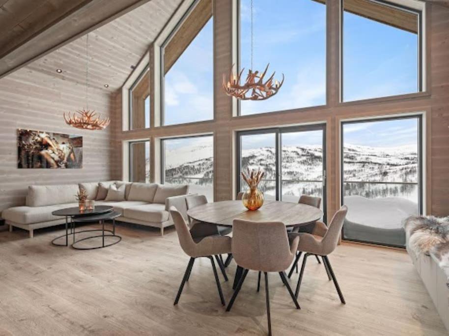 a large living room with a table and chairs at Flygende utsiktshytte med magisk utsikt in Sogndal