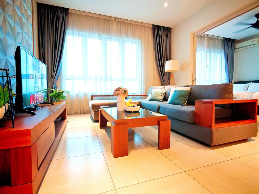 a living room with a couch and a tv at Ipoh Octagon Premium 7 Pax Condo One Free Parking by City Home Empire in Ipoh