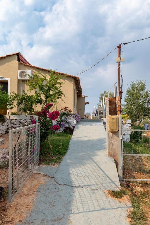 a walkway in front of a house with a fence at Disha Holiday Home in Ksamil