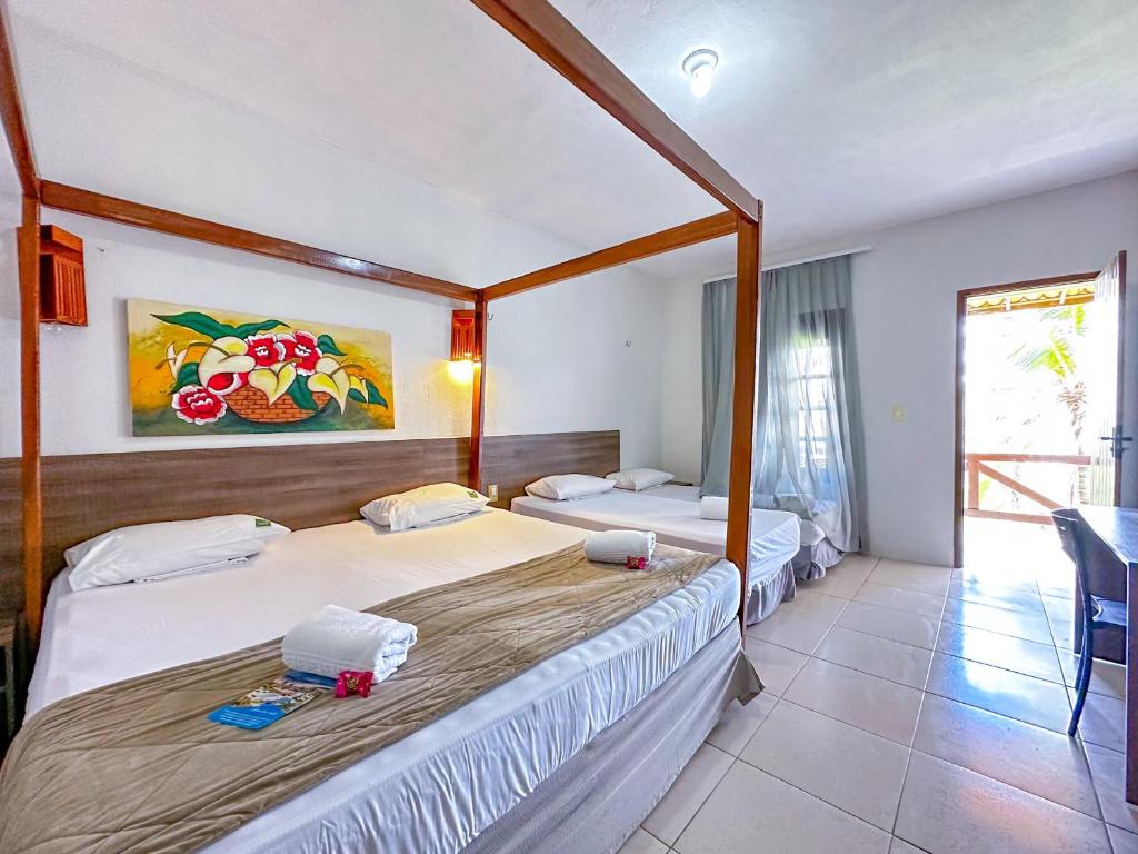 Postel nebo postele na pokoji v ubytování Jangadeiro Praia Hotel Resort - Parque Aquático e Pé na Areia