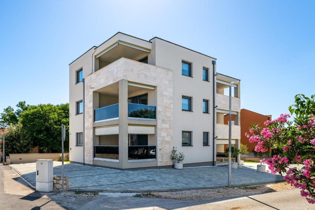 an image of a white building at Salt Bloom Apartments Nin in Nin