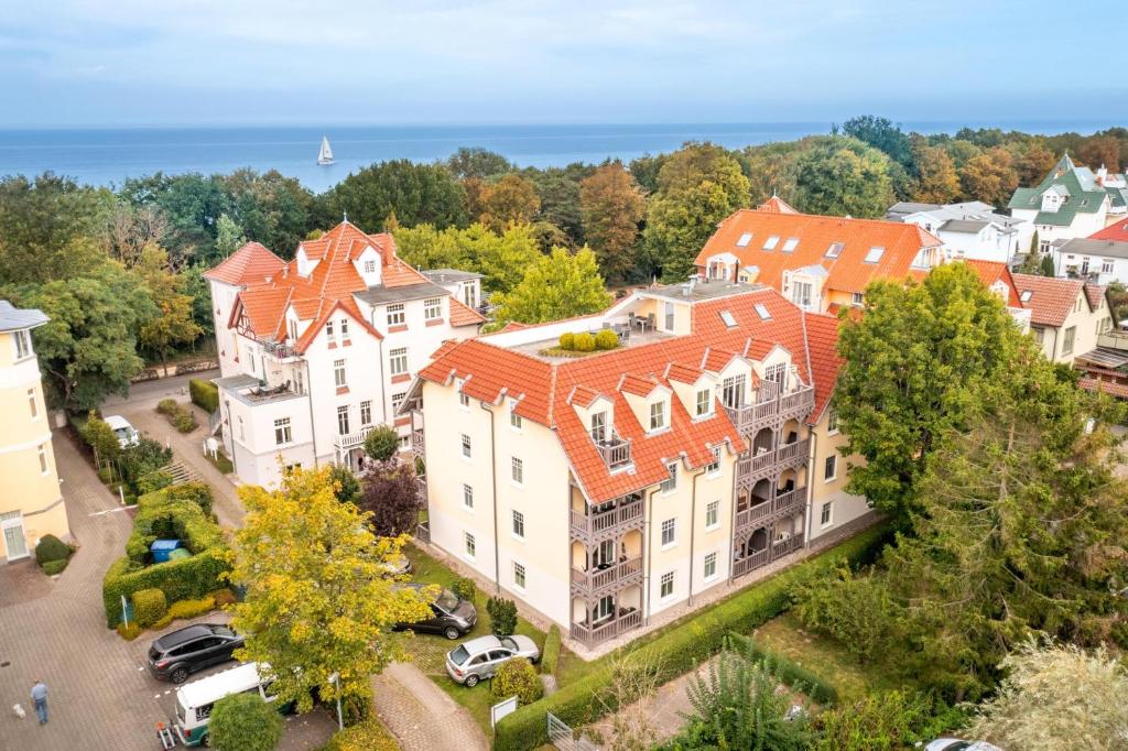an aerial view of a large white building with orange roofs at Ostseewelle 5 in Kühlungsborn