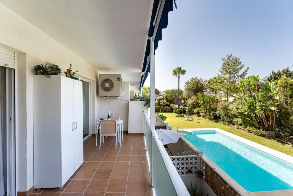 una vista dal balcone di una villa con piscina di MalagaSuite Marbella Pool Paradise a Marbella