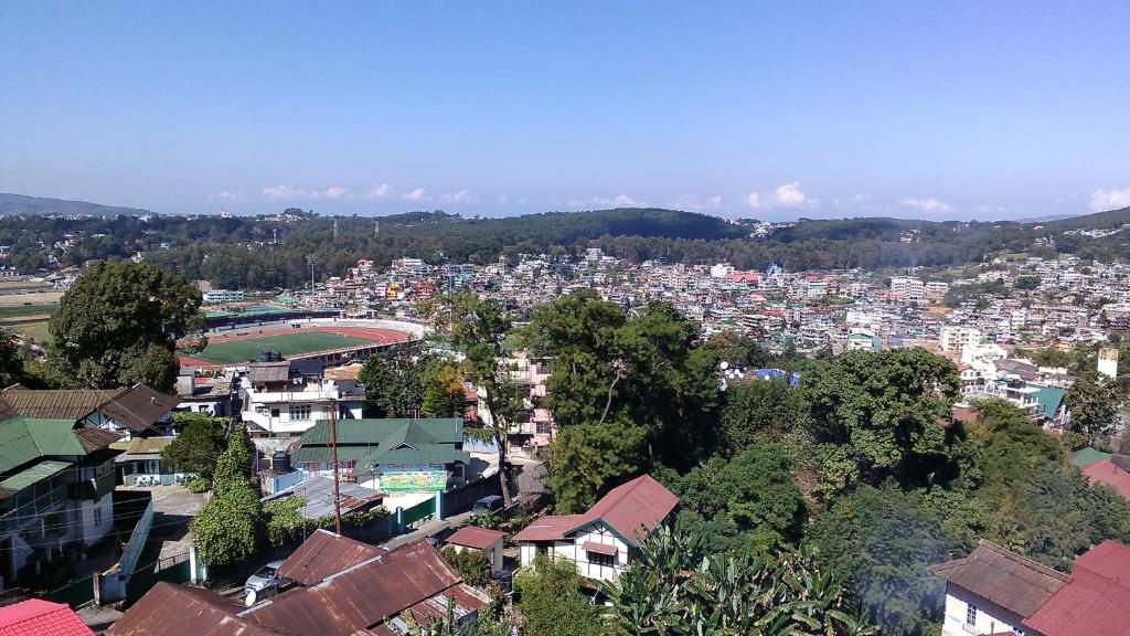 a view of a city with buildings and trees at The Shillong Hills Guest House in Shillong