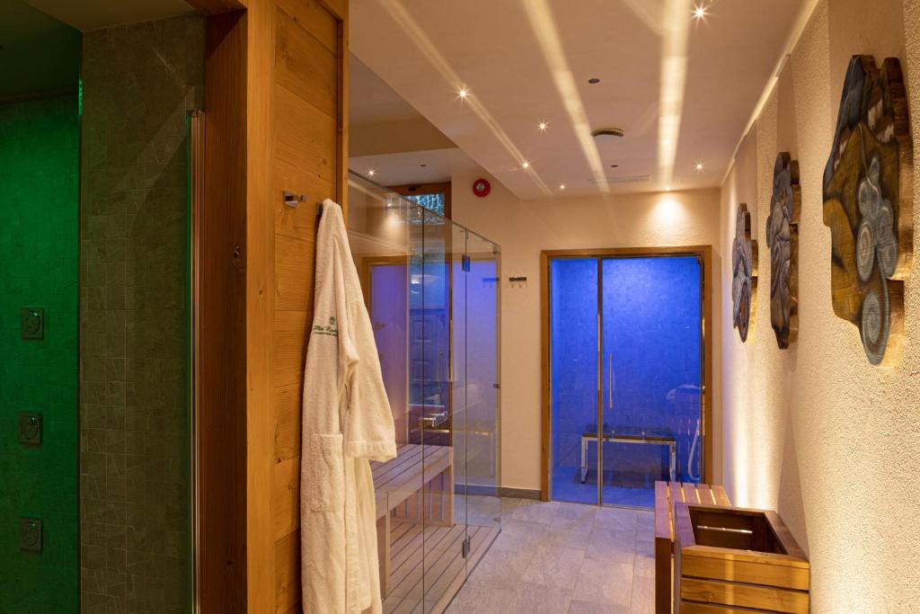 a bathroom with a shower and a glass door at Hotel Bouton d'Or - Courmayeur in Courmayeur