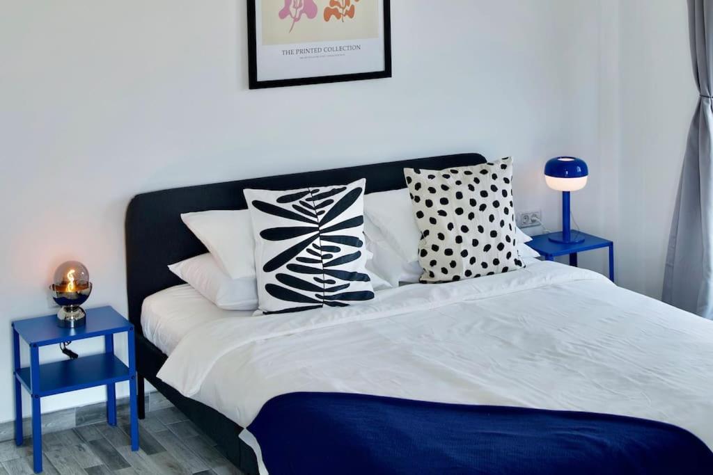 a bedroom with a blue and white bed with pillows at Bulldog Studio in Năvodari