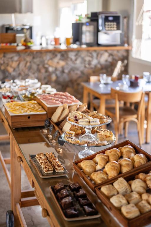 a buffet with many different types of pastries and cookies at Villa Mansa in Vistalba