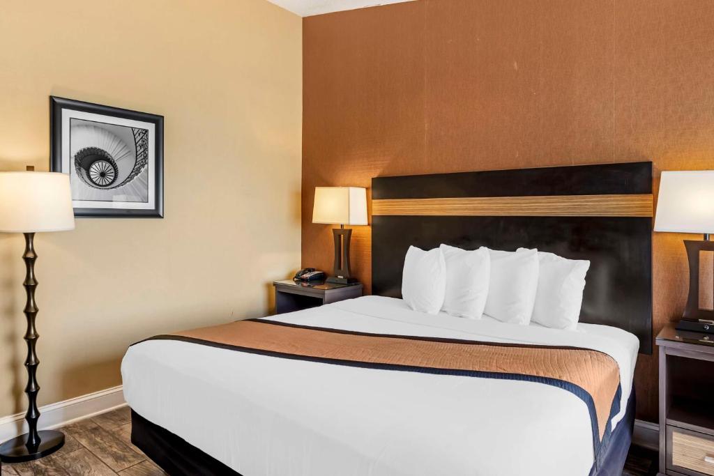 a hotel room with a large bed with two lamps at Best Western Plus Newark Airport West in Newark