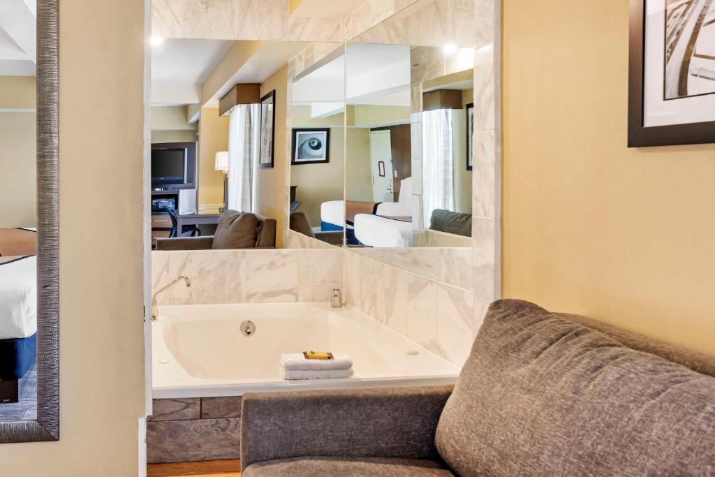 a bathroom with a large tub in a room at Best Western Plus Newark Airport West in Newark