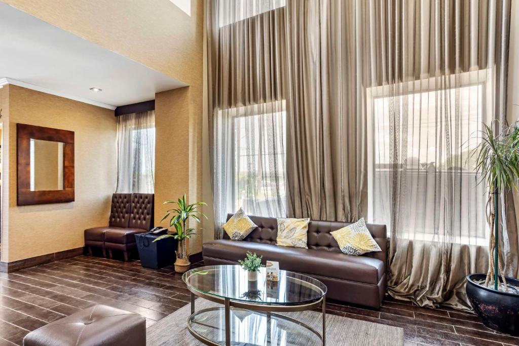 a living room with a couch and a glass table at Best Western Plus Newark Airport West in Newark