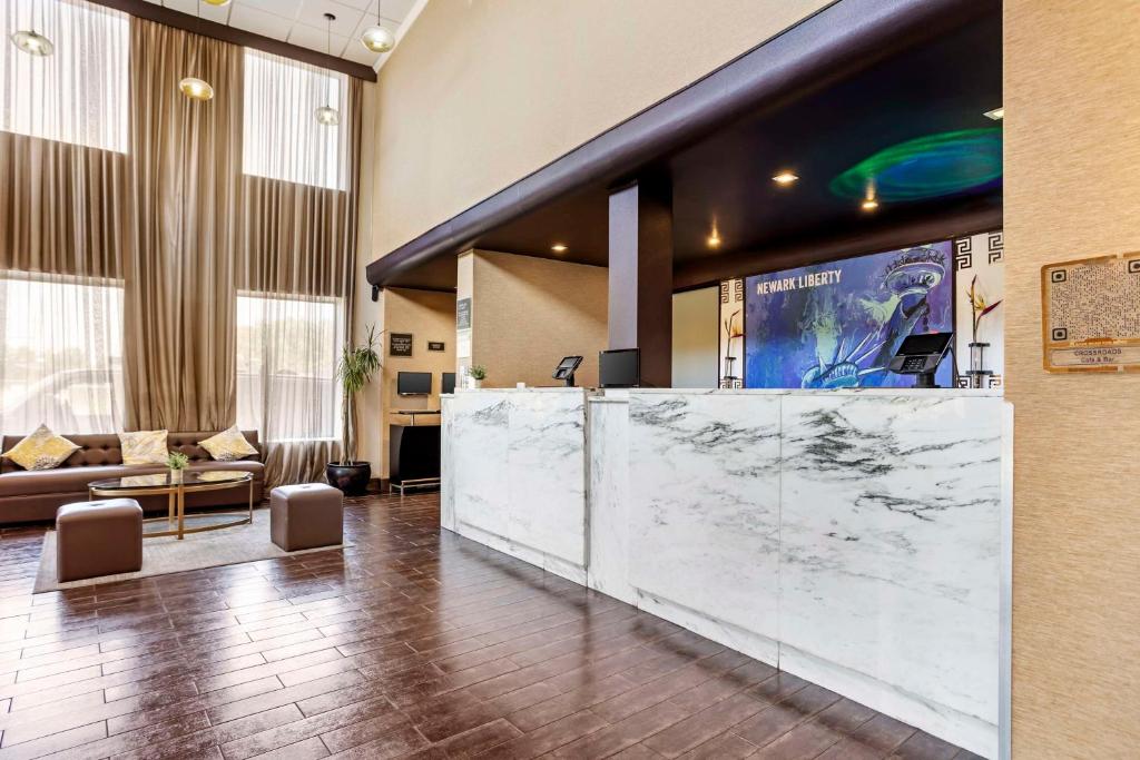 a lobby with a large marble counter and a couch at Best Western Plus Newark Airport West in Newark