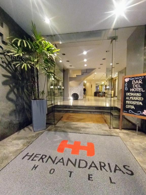 a lobby with a sign in the middle of a building at Hotel Hernandarias in Santa Fe