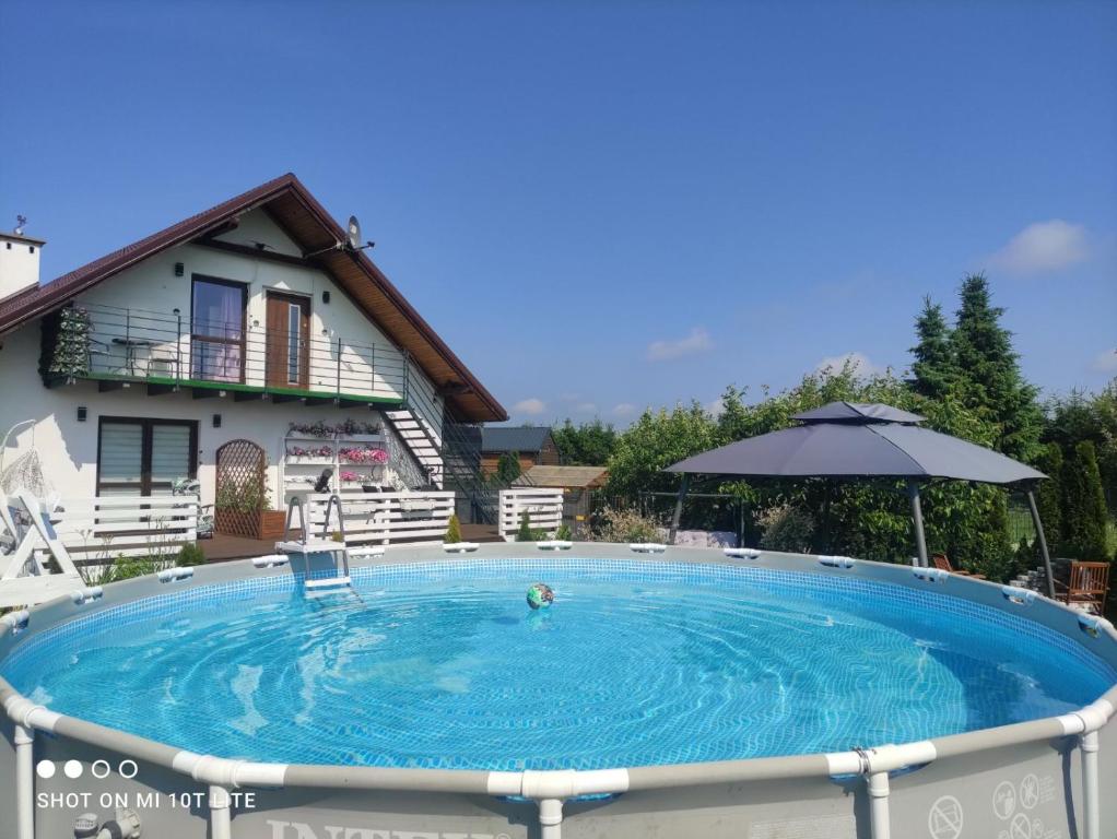 a large plunge pool in front of a house at Apartament u Małgosi in Kołczewo
