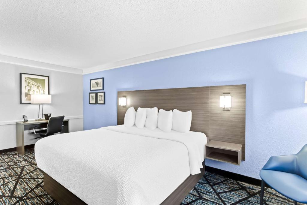 a hotel room with a large bed and a desk at Best Western Schaumburg – O’Hare NW in Schaumburg