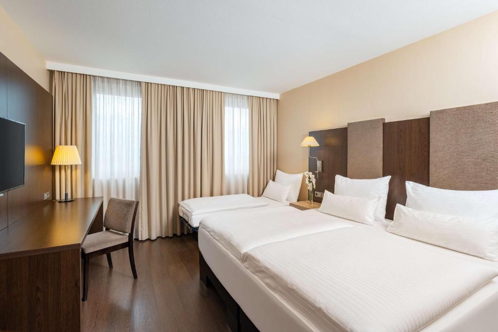 Postel nebo postele na pokoji v ubytování NH Danube City