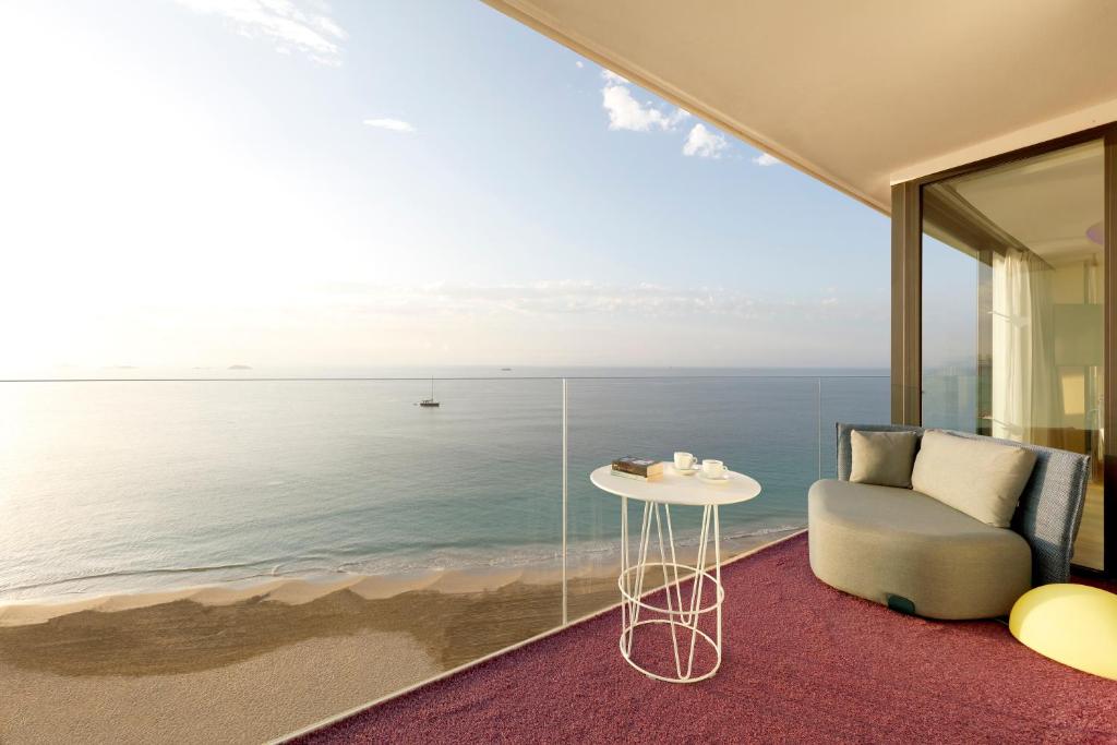 a living room with a view of the ocean at Hard Rock Hotel Ibiza in Playa d'en Bossa