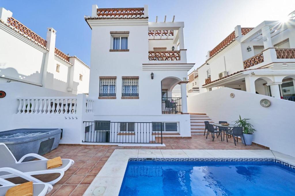 a villa with a swimming pool and a house at Villa Pura - Private Jacuzzi & Heated Pool in Nerja