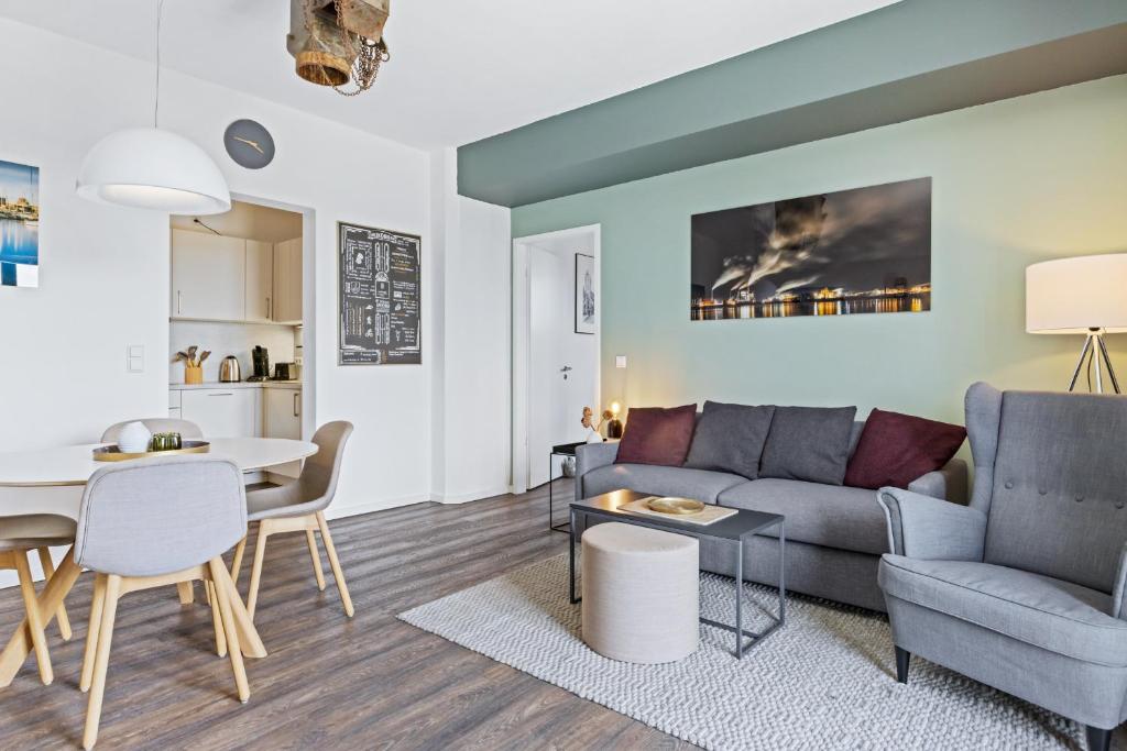 a living room with a couch and a table at Hafenlodge - Urlaub im Denkmal in Wismar