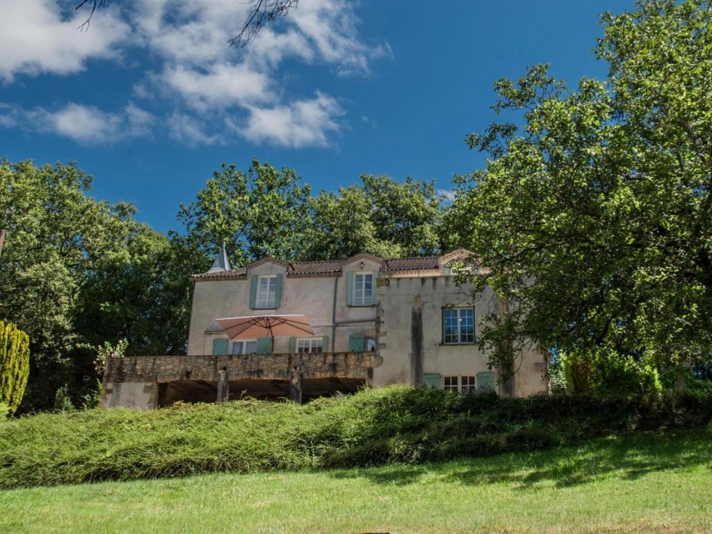 une ancienne maison en pierre sur une colline avec des arbres dans l'établissement Vigne Grande, à Puy-lʼÉvêque