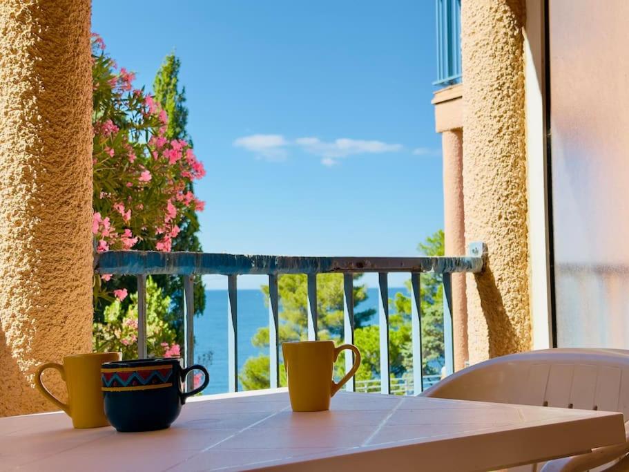 - deux tasses à café assises sur une table devant une fenêtre dans l'établissement Le Grand Large, à Collioure